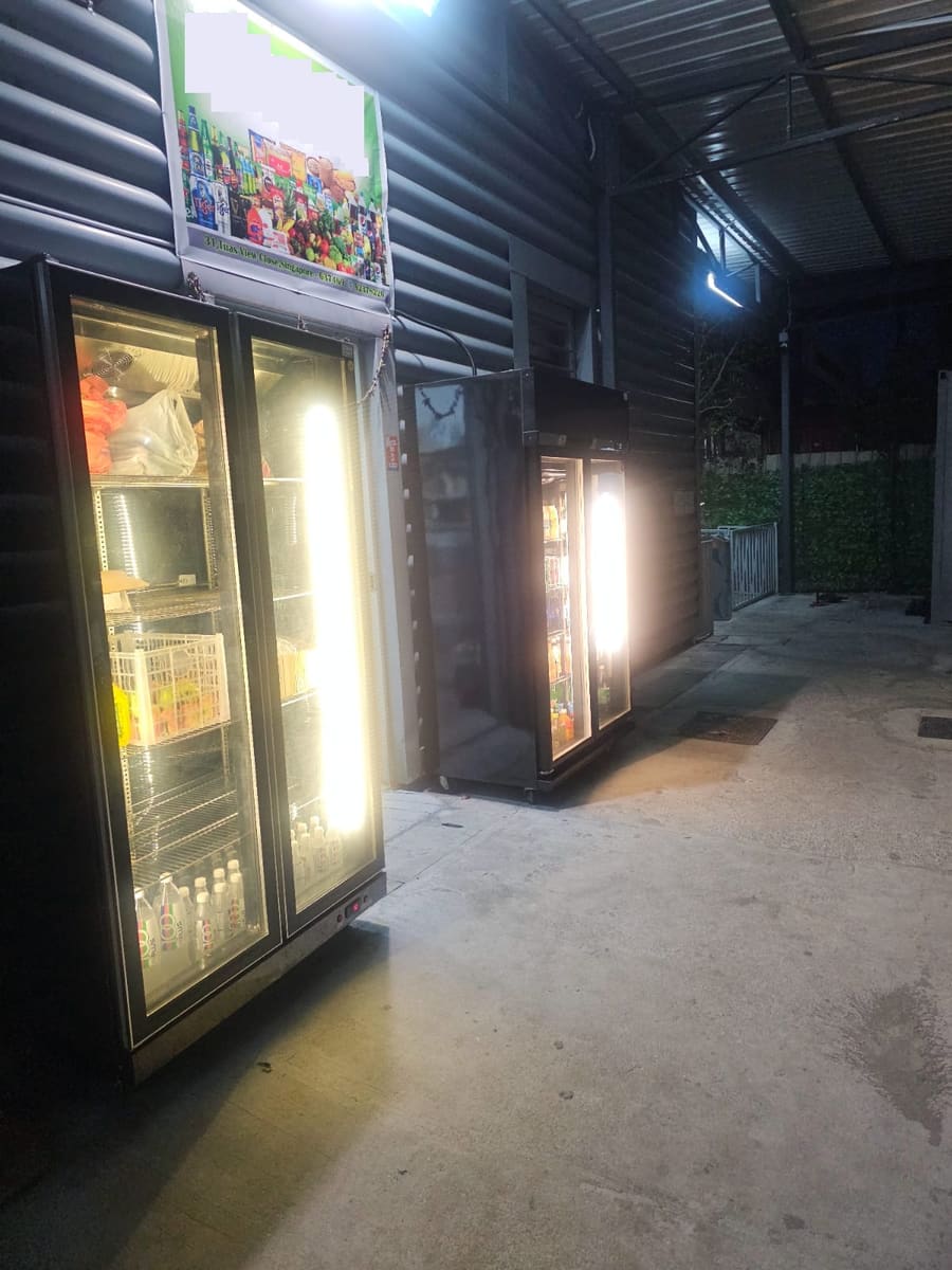 Minimart storefront with chiller fridges — NextDorm31@Tuas dormitory in Tuas, Singapore